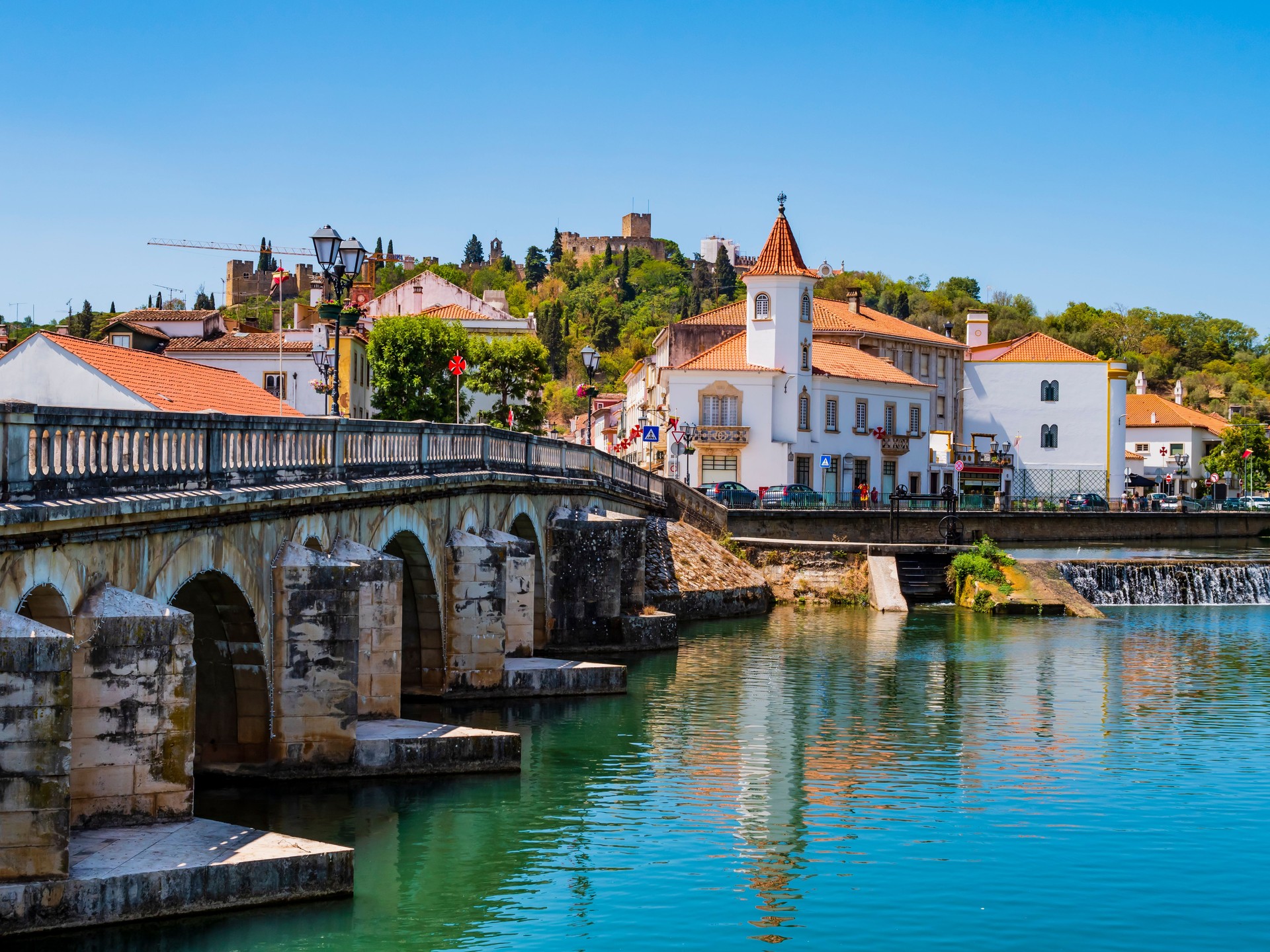 Old bridge (Ponte Vhela) over Nabao river, leading to the historic centre of Tomar, picturesque village in Santarem District, Portugal