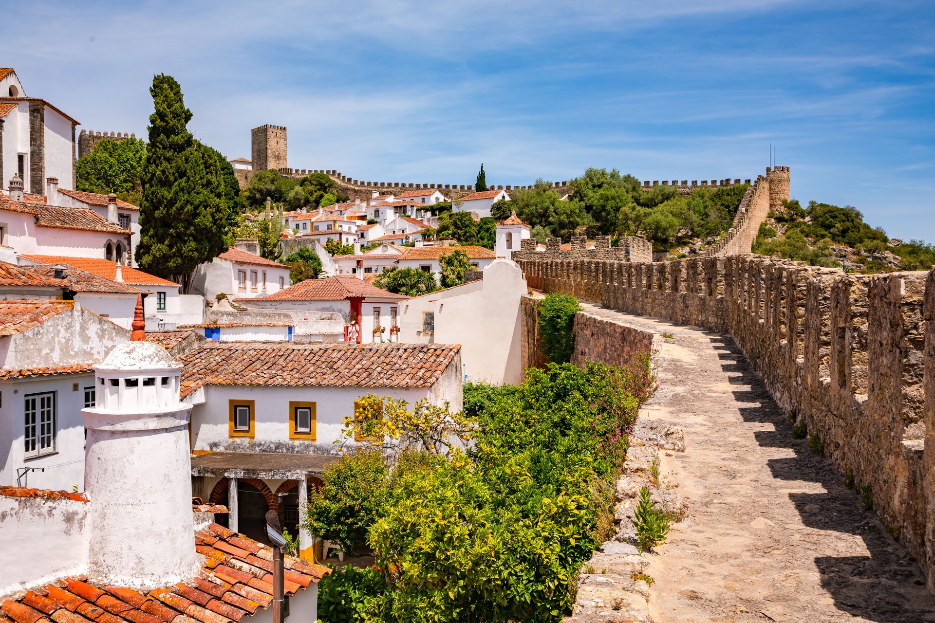 The castle and towers of the historic old town of Obidos with the city walls you can walk through, Portugal